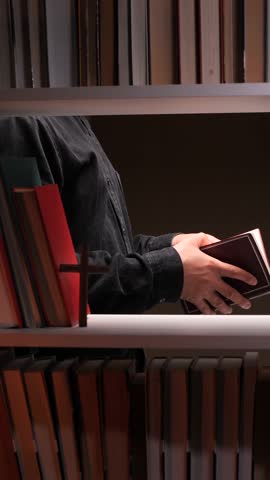 vertical video Priest reading holy book in the library