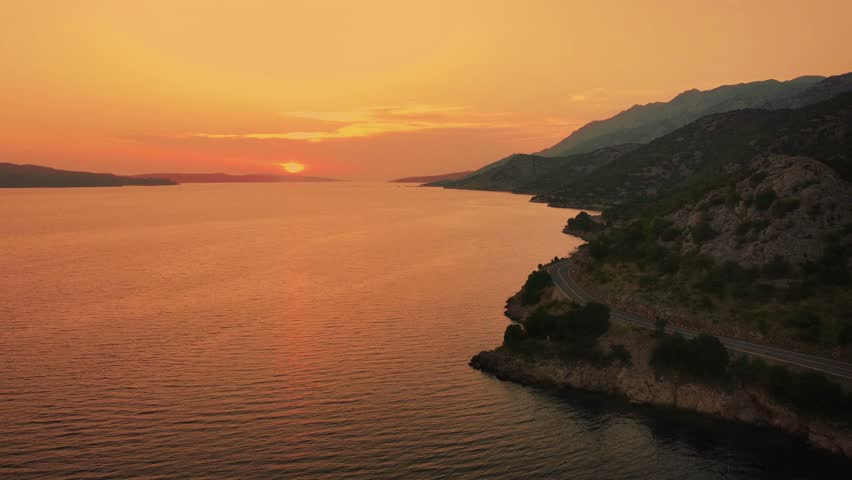 Aerial shot of sunset over the sea with Adriatic coastline in Croatia

