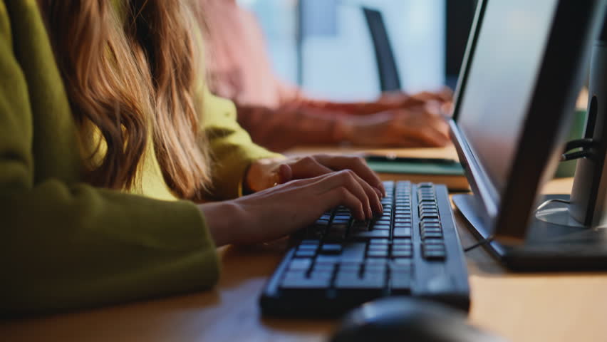 Consultant hands entering data on keyboard talking with client by headset closeup. Happy woman call center operator consulting customer. Friendly sales agent proposing company services typing computer