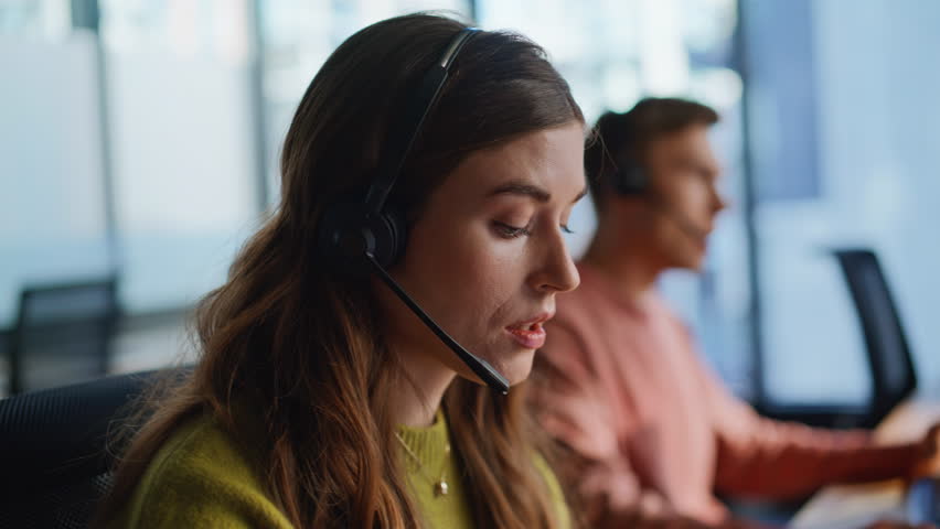Technical support woman speaking client in office portrait. Confident specialist talking remotely solving customer request on hotline. Serious agent operator consulting in headset. Student career job 