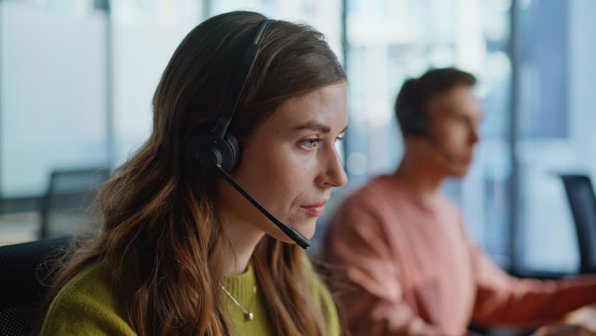 Thoughtful support agent listening customer at workplace closeup. Focused woman specialist helping client solving request on hotline. Professional manager work data center. Helpdesk operator concept 