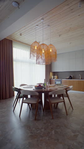 Handcrafted table beneath glowing basket pendants. Natural textures and warm light craft inviting farm-to-table vibe for lifestyle content.