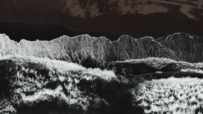 Aerial top view beach Khalaktyrsky black volcanic sand coast of North Pacific Ocean Kamchatka Russia.