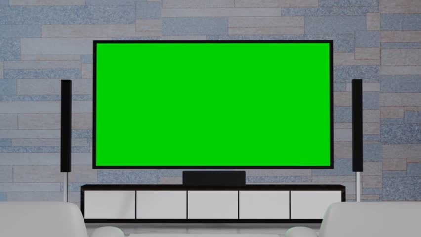 Modern living room with large flat-screen TV displaying a green screen, ready for chroma key content. Includes soundbar, speakers, and console against a textured brick wall. Home entertainment setup.