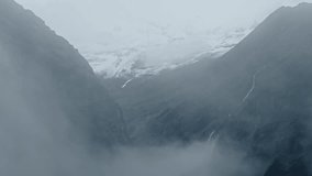 Rugged Rocky Mountains Background with Copy Space, Atmospheric Mood with Moody Mist and Clouds, Dramatic Himalayas Background with Copyspace in Muted Desaturated Nature Background - Powered by Shutterstock - Get 15% off with code: PIKWIZARD15