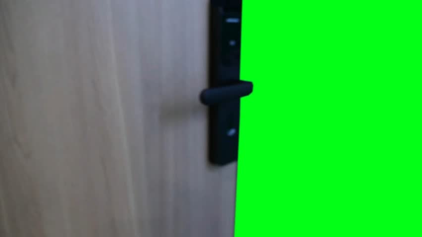 Wooden door with a modern black handle opens inwards, smoothly revealing a bright green screen area. Ideal for transitions, new opportunities, or content reveals.