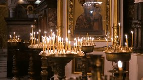 Votive candles flicker before a sacred icon inside St. Volodymyr's Cathedral in Kyiv, Ukraine. The warm candlelight creates a serene, spiritual atmosphere in the historic Orthodox landmark. - Powered by Shutterstock - Get 15% off with code: PIKWIZARD15