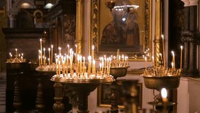 A serene atmosphere fills the historic St. Volodymyr's Cathedral in Kyiv as candlelight glows before a sacred Orthodox icon. The flickering flames create a peaceful and contemplative ambiance. - Powered by Shutterstock - Get 15% off with code: PIKWIZARD15
