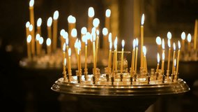Flickering candlelight illuminates the sacred interior of St. Volodymyr's Cathedral in Kyiv, Ukraine. Votive candles offer prayers for hope and peace inside the historic Orthodox landmark. - Powered by Shutterstock - Get 15% off with code: PIKWIZARD15