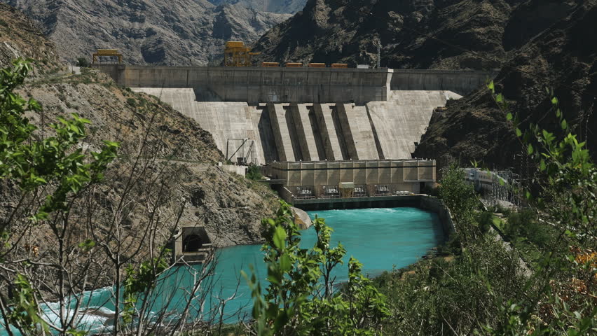 Generating electricity from water. A powerful hydroelectric power station in the mountains on a river with turquoise water.