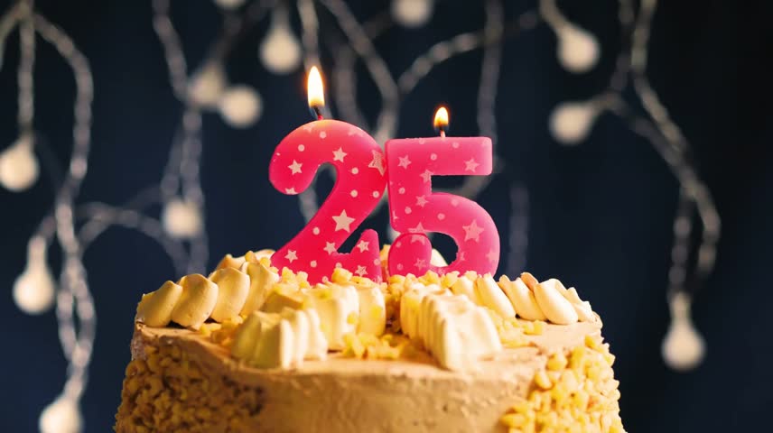Elegant 25th birthday celebration with a pink number 25 candle on a frosted cake. Captured in slow motion as the candle is blown out, set against a vibrant lighting background 