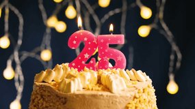 Elegant 25th birthday celebration with a pink number 25 candle on a frosted cake. Captured in slow motion as the candle is blown out, set against a vibrant lighting background  - Powered by Shutterstock - Get 15% off with code: PIKWIZARD15