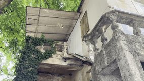 Old Abandoned European Building with Crumbling Staircase and Weathered Balustrade. Decaying Facade with Vintage Architectural Details. Derelict Structure Showing Signs of Neglect, Time and Urban Decay - Powered by Shutterstock - Get 15% off with code: PIKWIZARD15