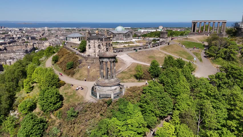 Aerial footage of Calton Hill overlooking Edinburgh, Scotland, United Kingdom