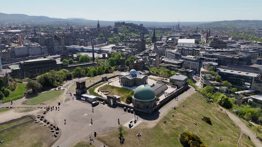 Flight over Calton Hill towards Edinburgh city center, Scotland, United Kingdom