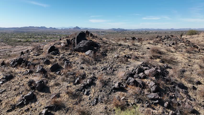 Aerial view of rocky terrain and desert landscape with mountains under a clear sky, Sonoran Preserve, Phoenix, Arizona, United States.