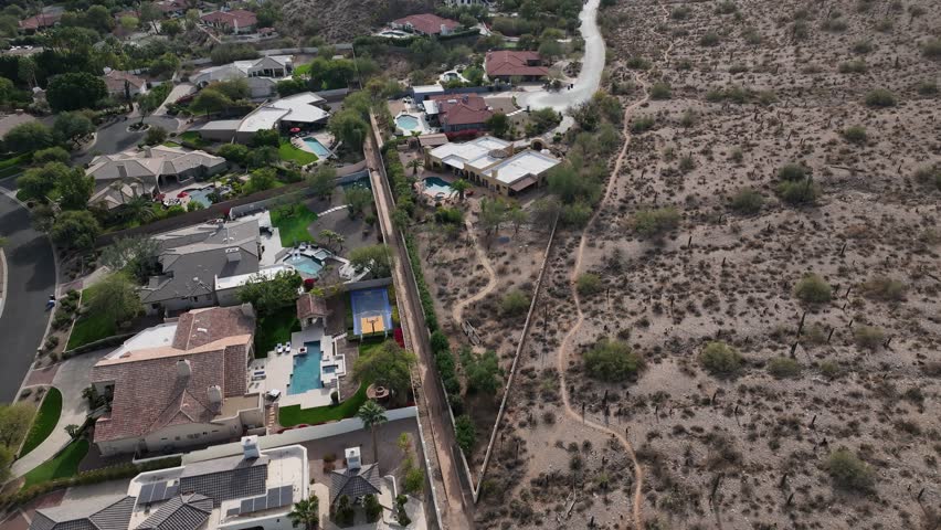 Aerial view of phoenix mountains with suburban homes and rugged terrain, Phoenix, Arizona, United States.