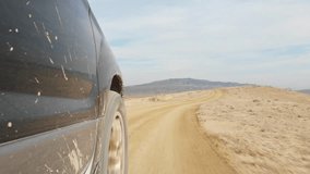 SUV driving through gravel dirt road on hilly terrain. Off-road adventure, freedom travel, outdoor exploration, automotive endurance, rugged landscape, lifestyle escape and wilderness autumn journey. - Powered by Shutterstock - Get 15% off with code: PIKWIZARD15
