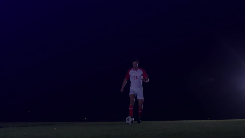 male soccer player dribbling and dodging sliding tackle to keep ball with 3D sports tech overlay. Athletic, competitive, futuristic, digital, strategy, motion, determination