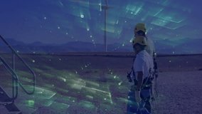 Two technicians walking across wind farm activating holographic grid scan and inspecting projection. Technicians, safety, hologram, digital, technology, outdoor, industry - Powered by Shutterstock - Get 15% off with code: PIKWIZARD15