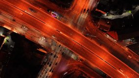 car traffic transportation on road at junction intersection, 4K. Aerial view of road interchange or highway intersection with busy urban traffic speeding on the road at night. expressway, highway road - Powered by Shutterstock - Get 15% off with code: PIKWIZARD15