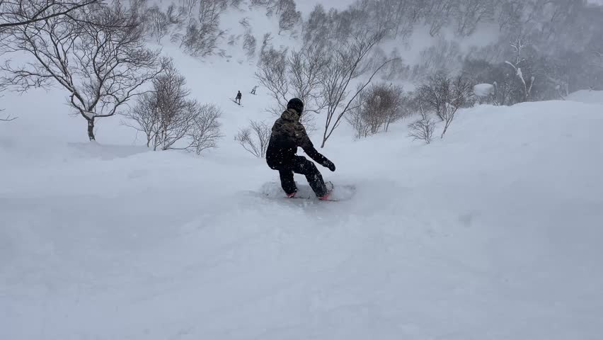 Man snowboarding in Hokkaido in Niseko
