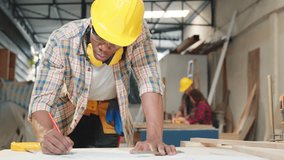 Carpenter sketching table plans on wood at a working desk. builders and engineers designing furniture and home renovation projects, craftsmanship and precision in woodworking, National Carpenters Day - Powered by Shutterstock - Get 15% off with code: PIKWIZARD15