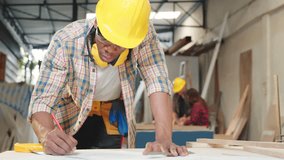 Carpenter sketching table plans on wood at a working desk. builders and engineers designing furniture and home renovation projects, craftsmanship and precision in woodworking, National Carpenters Day - Powered by Shutterstock - Get 15% off with code: PIKWIZARD15