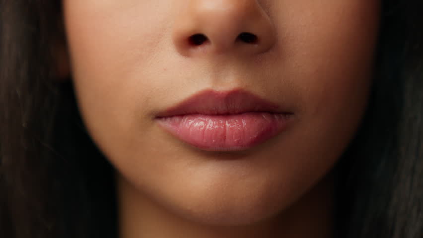 Silence gesture close up female mouth latino hispanic woman unrecognizable ethnic girl hush lips put finger stop talk secret whisper quite secrecy silent confidential mysterious sign cropped view face