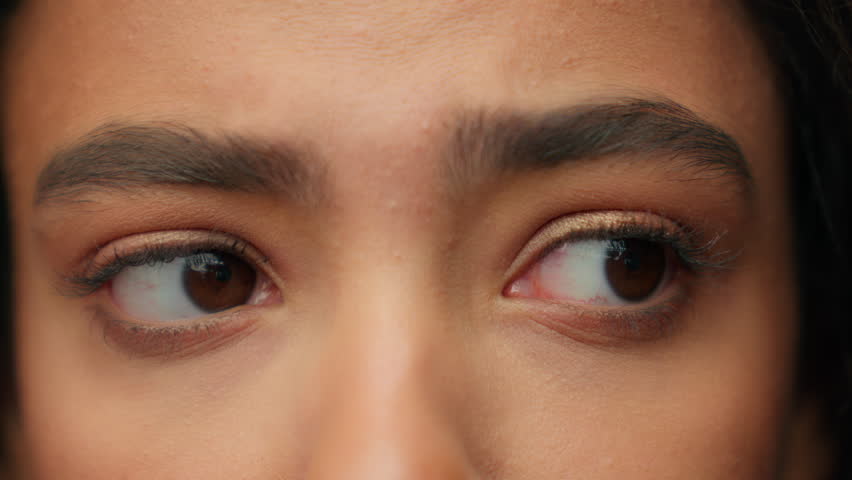 Close up eyes human face part Hispanic Latina woman teen girl sad confused stressed looking at sides female eye dark eyeball eyelashes look away gaze vision eyesight health care medical consultation