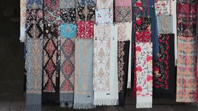 Pashminas with various colors and patterns hanging at a street market stall - Powered by Shutterstock - Get 15% off with code: PIKWIZARD15