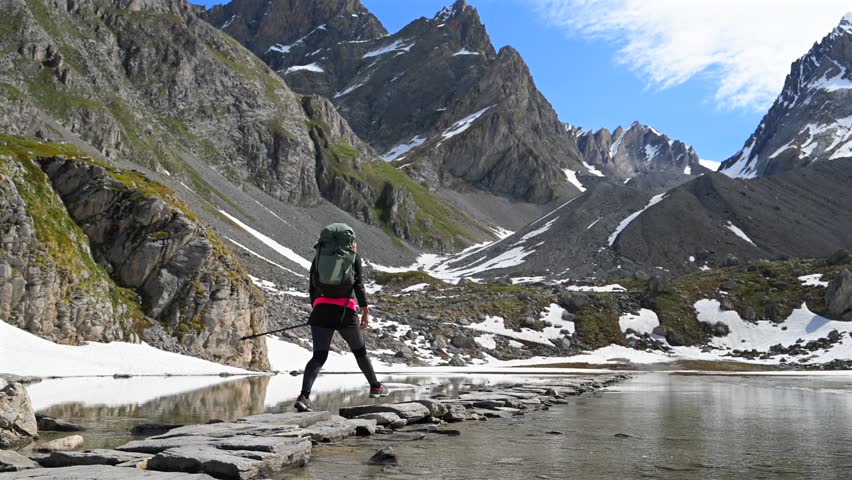 Beautiful hiking trail across reflection lake in the Alps - Col de la Vanoise in the French Alps