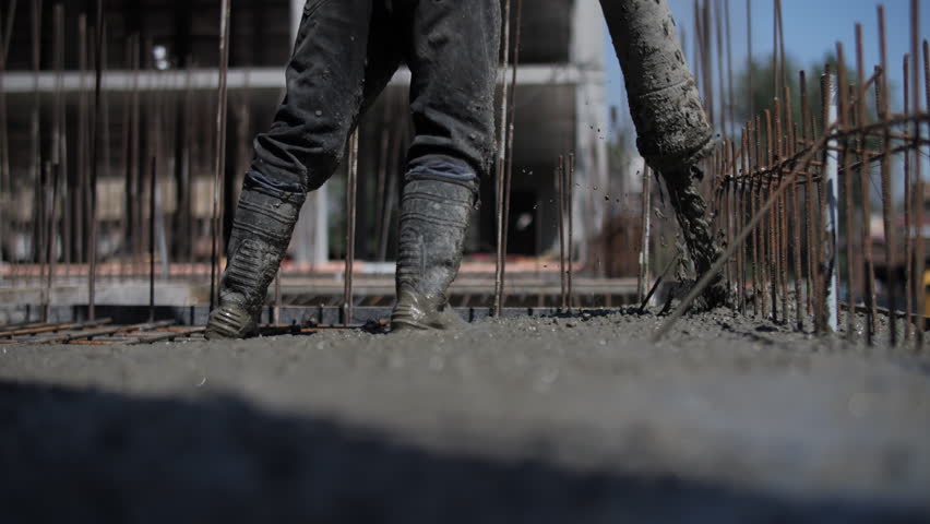 Concrete pouring on reinforced foundation at construction site