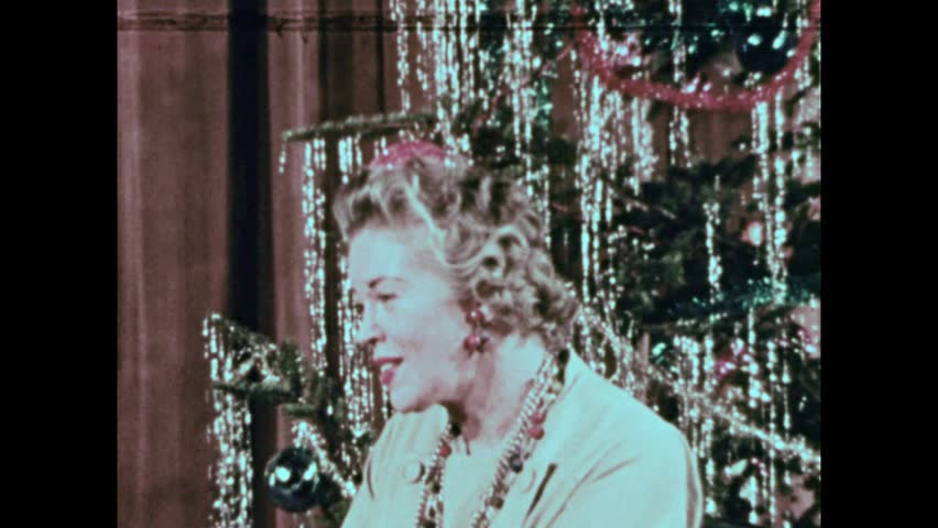 United States CIRCA United States 1950s: Italian children dance in traditional costumes. Group of children sit around woman and Christmas tree.