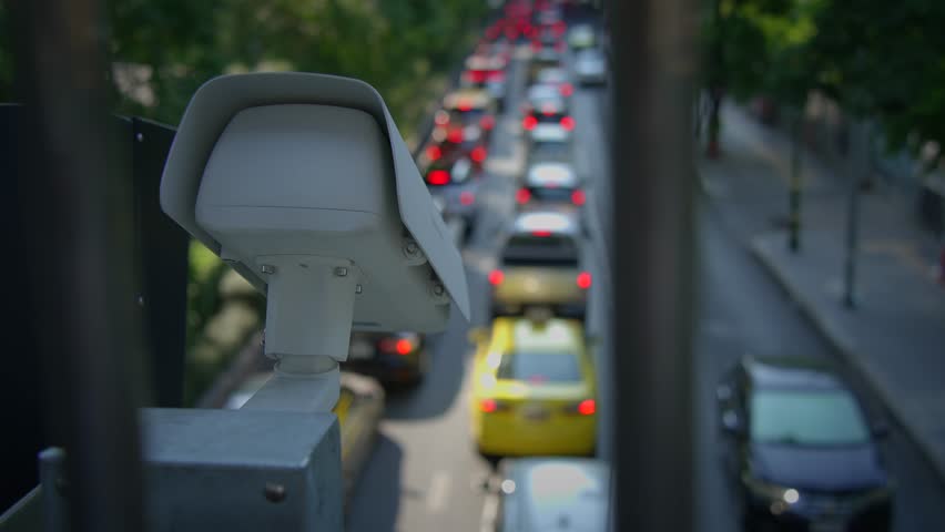Closeup of a surveillance camera against a vibrant blue sky, ensuring safety and effective area monitoring