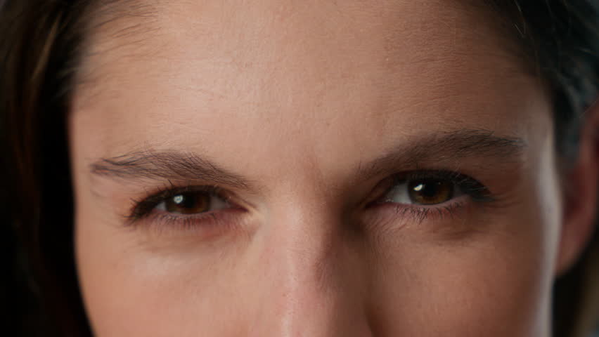 Close up extreme view eyes aggression stressed woman aggressive human dark eyeballs female stress eyesight angry annoyed anger girl gaze staring looking front eye vision sight irritated strong rage 