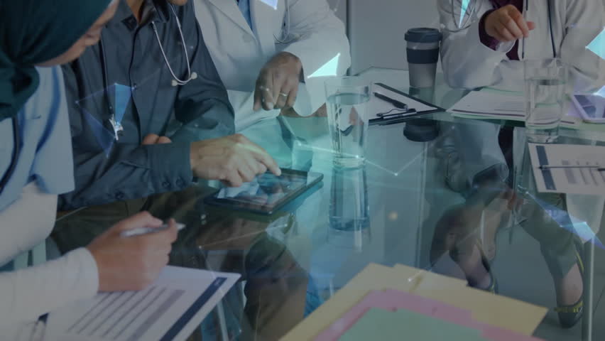 Male doctor tapping tablet showing holographic medical network lines while colleagues noting forms. Medical, collaboration, innovation, technology, healthcare, professionalism, holographic - Powered by Shutterstock - Get 15% off with code: PIKWIZARD15