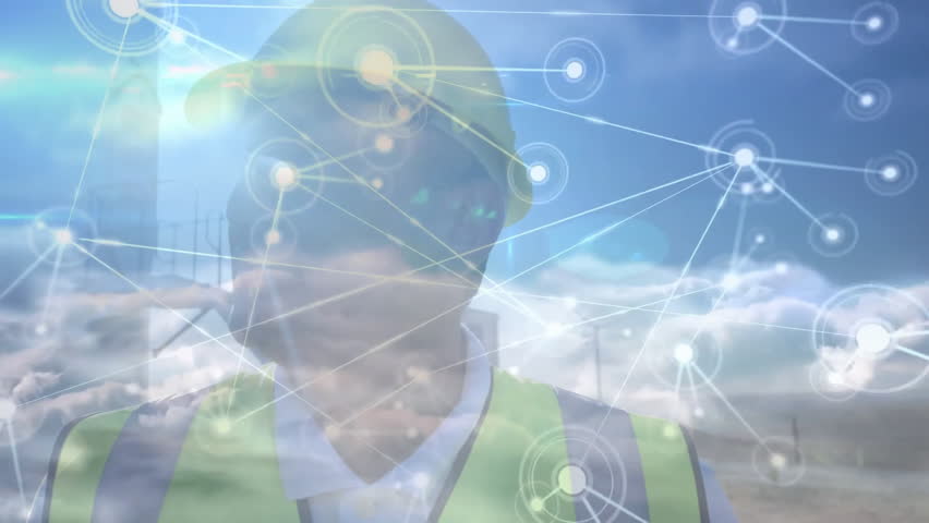 Construction worker initiating pulsing data network at chest, forming overlay linking site elements. Industrial, technology, connectivity, safety, infrastructure, digital, systems - Powered by Shutterstock - Get 15% off with code: PIKWIZARD15