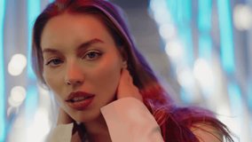 Stylish Woman Posing with Neon Lights in Urban Background. Portrait of a stylish young woman posing confidently with neon lights in the background, creating a modern, urban atmosphere. - Powered by Shutterstock - Get 15% off with code: PIKWIZARD15