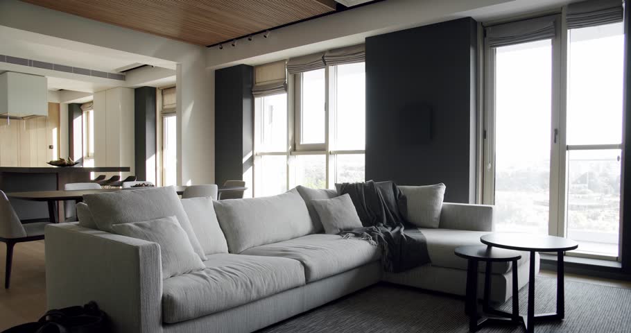 Modern contemporary Minimalist living room with confortable white sofa furniture. Luxury Modern House Interior With Corner Sofa. Fashionable furniture. Minimalist Home Interior. Luxury Elegant Room