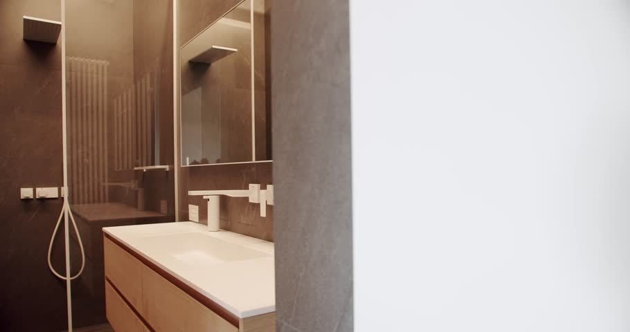 Modern bathroom with simplicity design. Luxury Bathroom Interior, Minimalist interior in brown colors with bathroom accessories , mirror and shower head, bathtub modern design. Luxury cozy Apartment.