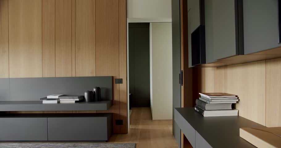 Modern contemporary Minimalist living room with wooden wall and gray furniture.Minimalist Home Interior with modern shelves and book. Cozy Modern Furniture Design. Luxury Elegant Room with wooden door