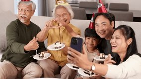 A joyful family captures a birthday moment with cake and selfies. Bright lighting and cheerful expressions create a warm atmosphere - Powered by Shutterstock - Get 15% off with code: PIKWIZARD15