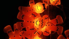 Glowing Christmas garland with golden shimmer on dark wood background. Cozy winter holidays atmosphere. 4k footage - Powered by Shutterstock - Get 15% off with code: PIKWIZARD15