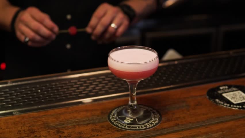 A Bartender Prepared A Fruit Cocktail Drink In A Bar. Close-up Shot