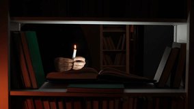 Person reading a book by candlelight in a dark library - Powered by Shutterstock - Get 15% off with code: PIKWIZARD15