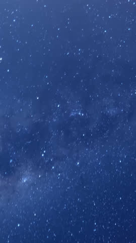 Time-lapse of Milky Way galaxy and moonrise over mountain landscape at night. Starry sky with bright moon, cosmic motion, and serene nature scene showcasing celestial nighttime beauty.