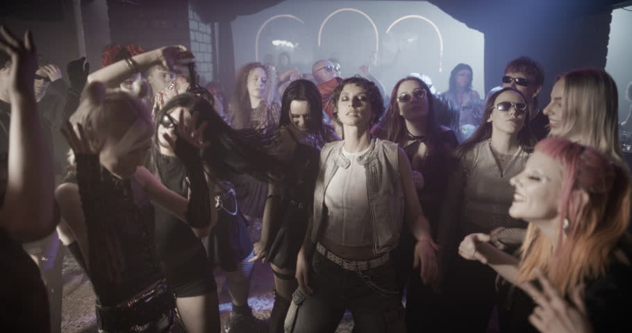 Creative People Move to Energetic Techno Rhythms in a Dark, Color-Drenched Club with Flashing Stroboscopes. Cinematic Slow Motion Footage Celebrating Nightlife, Youth Culture, Freedom and Urban Energy