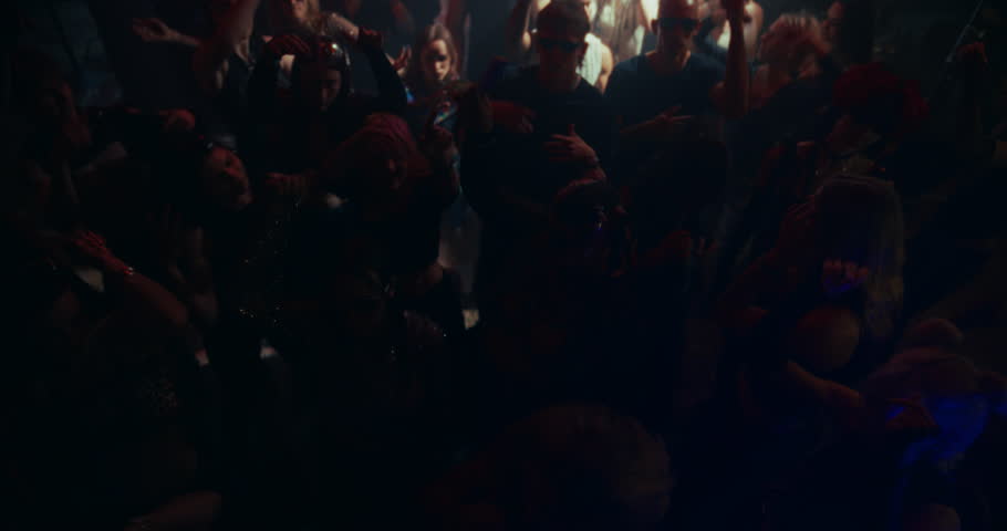 High Angle Slow Motion Footage with People Moving to Energetic Techno Rhythms in a Dark, Color-Drenched Club with Flashing Stroboscopes. Celebrating Nightlife, Youth Culture, Freedom and Urban Energy