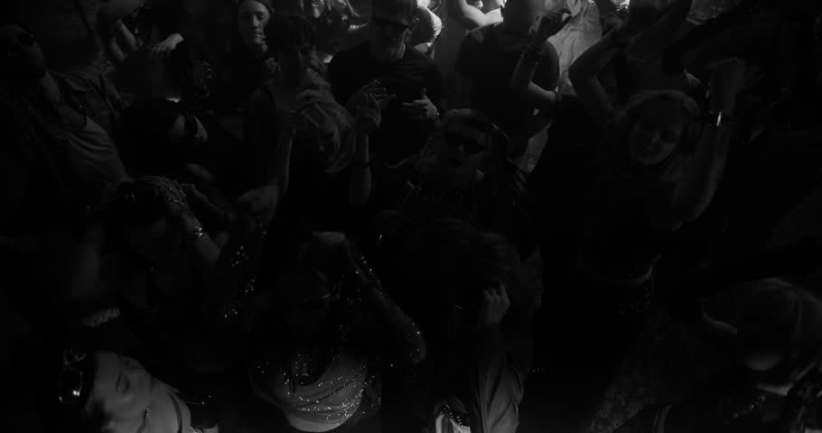 Party Crowd Enjoying Time in a Nightclub, Dancing Energetically Under Lights and Pulsating Music. Young Men and Women Having an Emotional Night Out. Slow Motion Top Down Black and White Footage